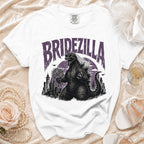 White t-shirt with "Bridezilla" text, Godzilla holding flowers.