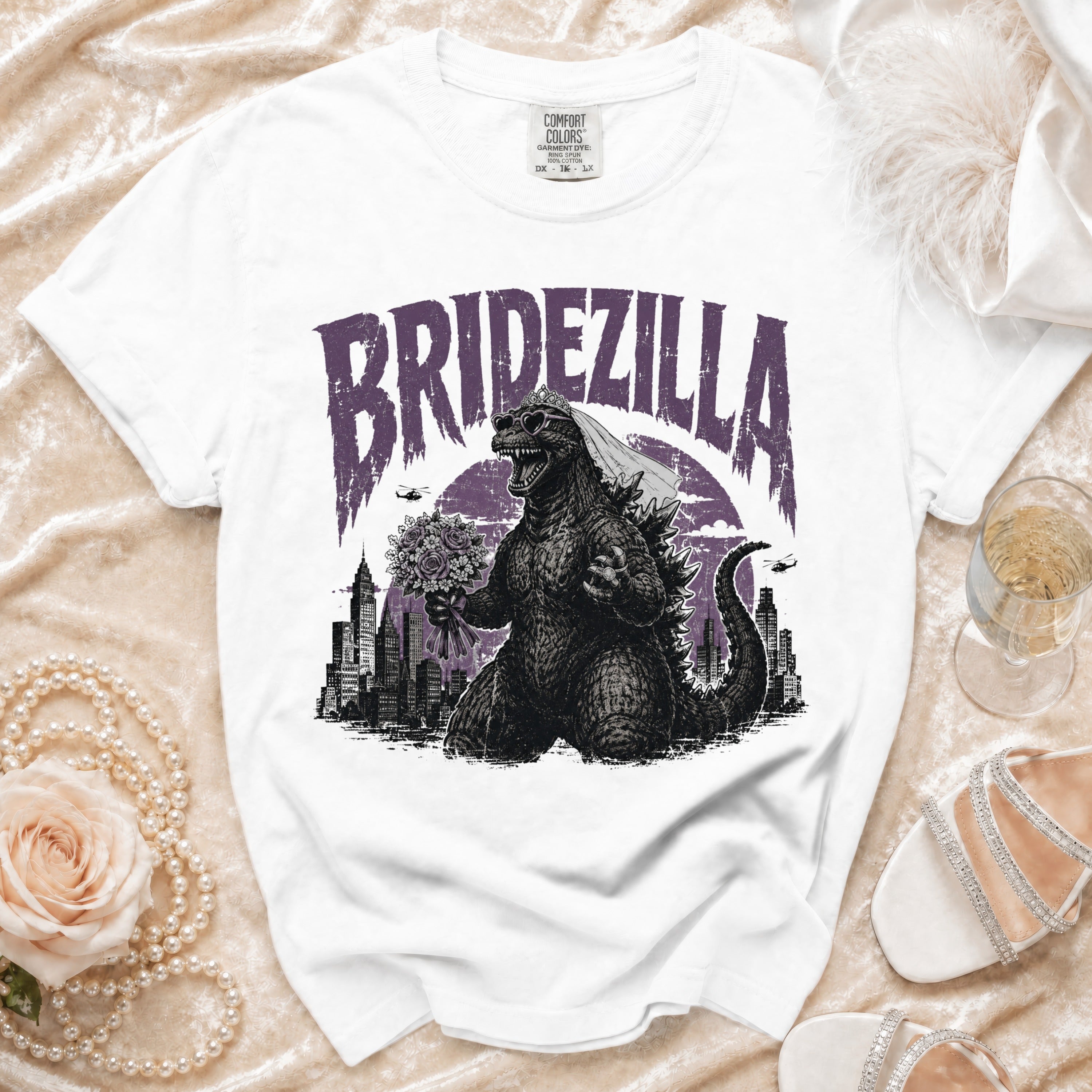 White t-shirt with "Bridezilla" text, Godzilla holding flowers.