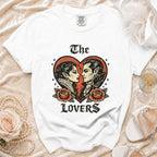 White t-shirt with gothic vampire couple and roses graphic, reads "The Lovers."