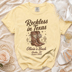 Yellow t-shirt with "Reckless in Texas" and "Olivia's Bach Austin, TX Summer 2026" text.