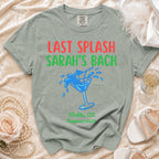 Green t-shirt with "Last Splash Sarah's Bach" text and cocktail graphic.