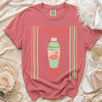 Coral t-shirt with "Last Splash" text and flamingo in cocktail shaker graphic.
