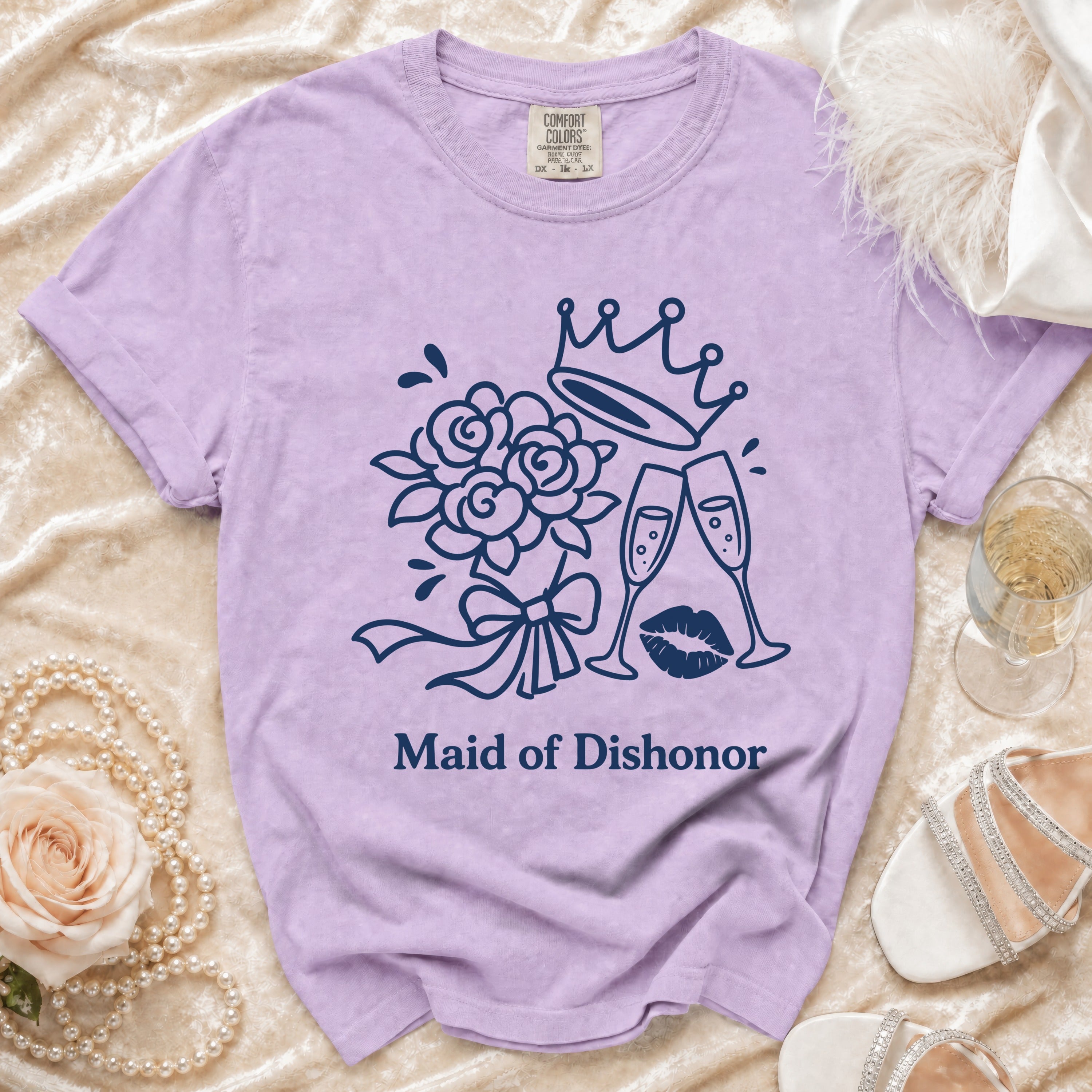 Purple t-shirt with "Maid of Dishonor" graphic featuring crown, flowers, champagne, and lips.