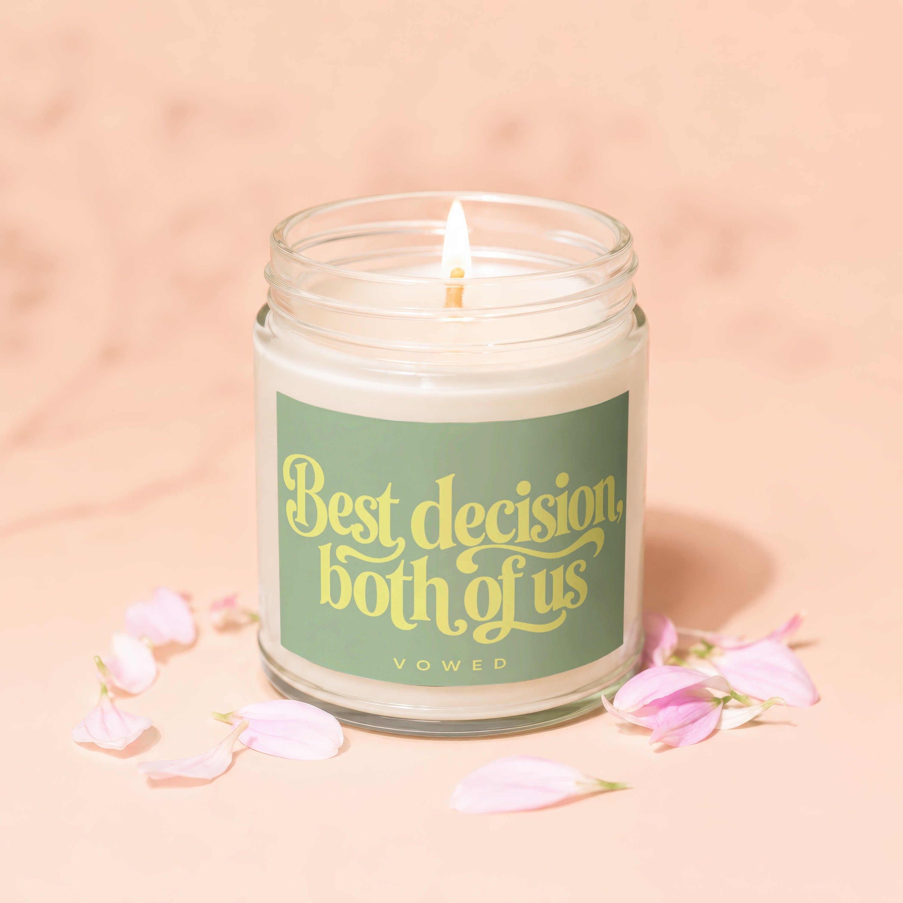 Candle with lit wick and label reading "Best decision both of us VOWED".