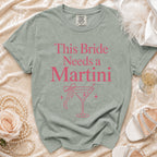 Light green t-shirt with "This Bride Needs a Martini" text and martini glass graphic.