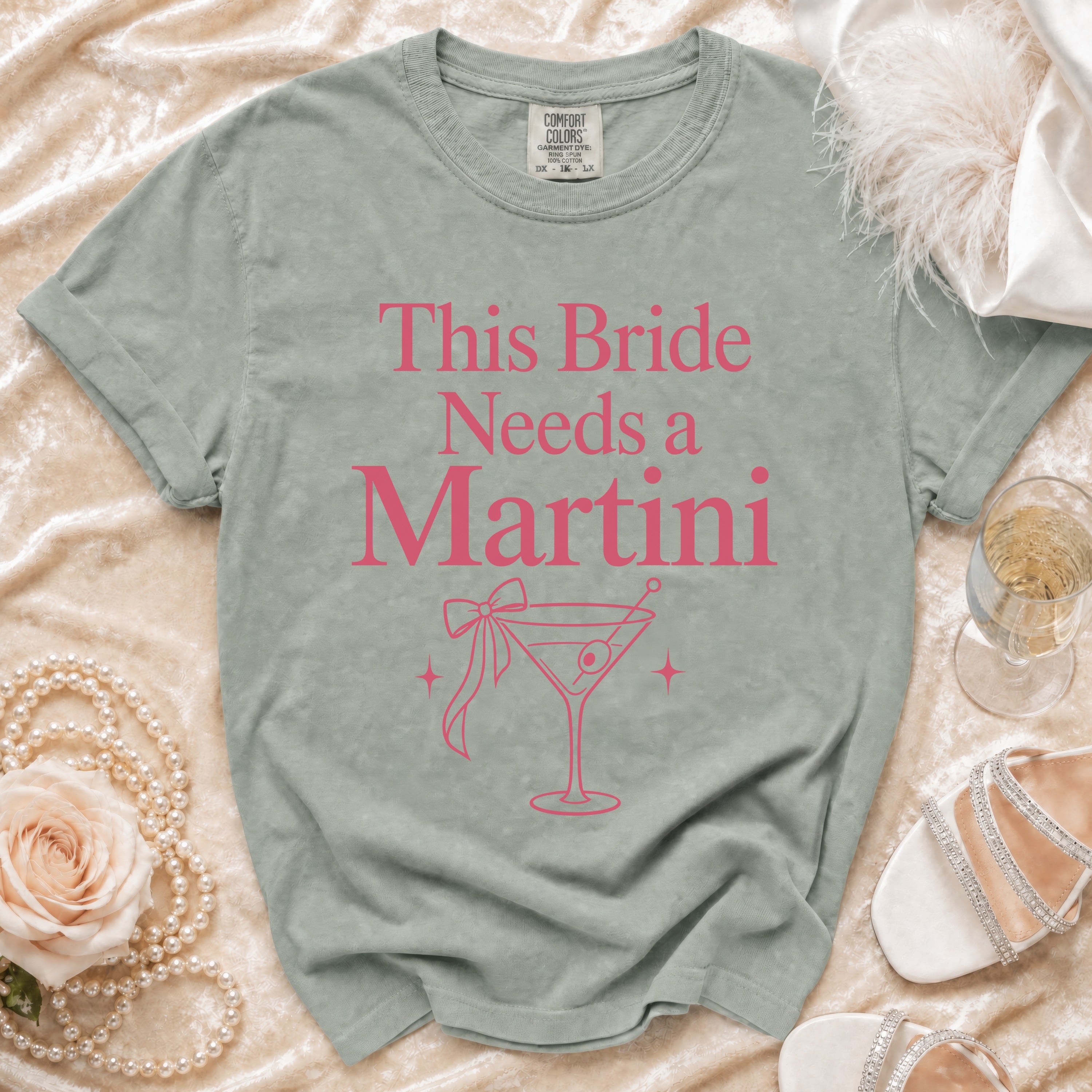 Light green t-shirt with "This Bride Needs a Martini" text and martini glass graphic.