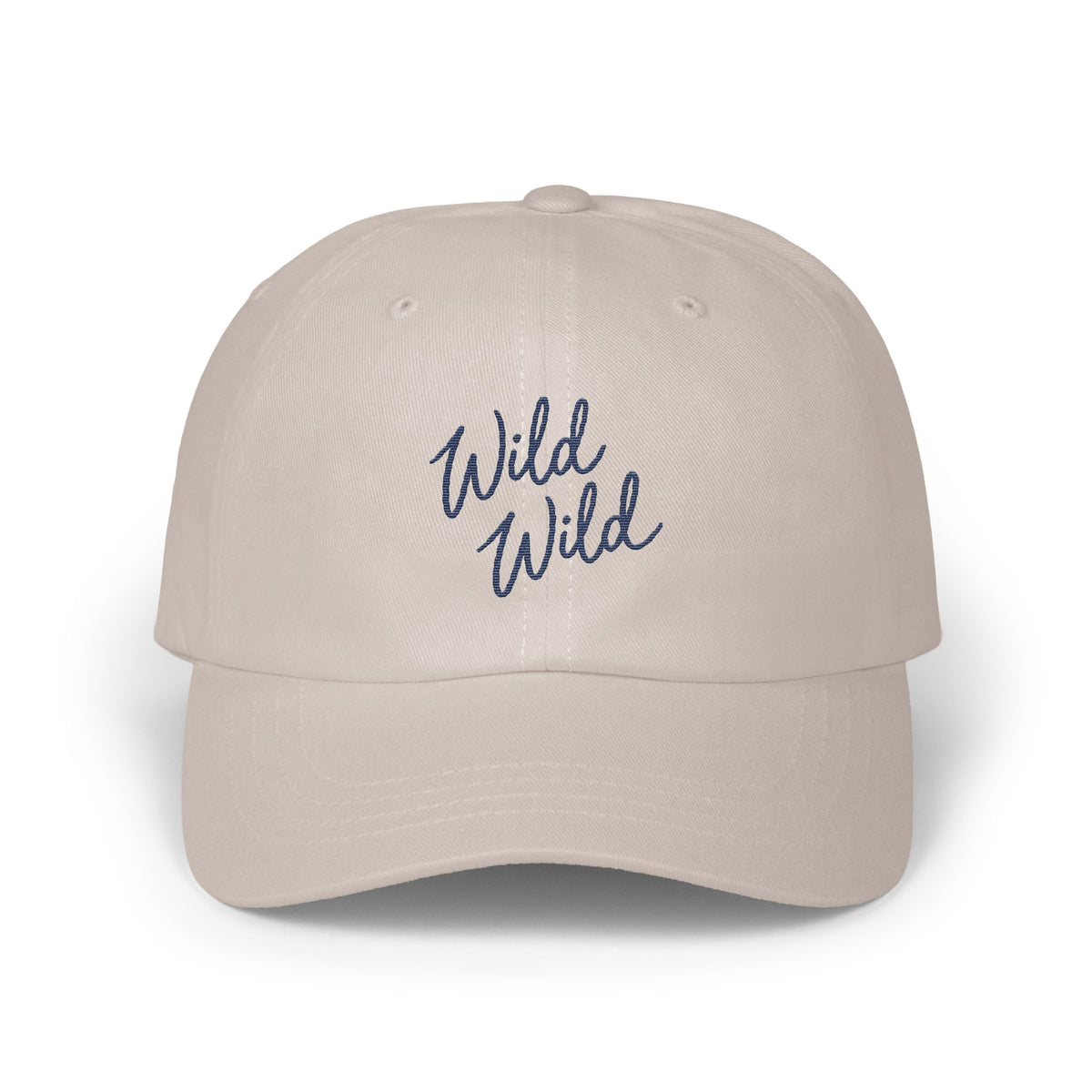 Light beige dad hat with blue cursive text embroidered reading Wild Wild.