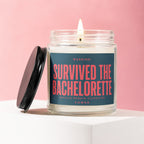 Jar candle with a lit wick, labeled "Survived The Bachelorette. Details Remain Classified."