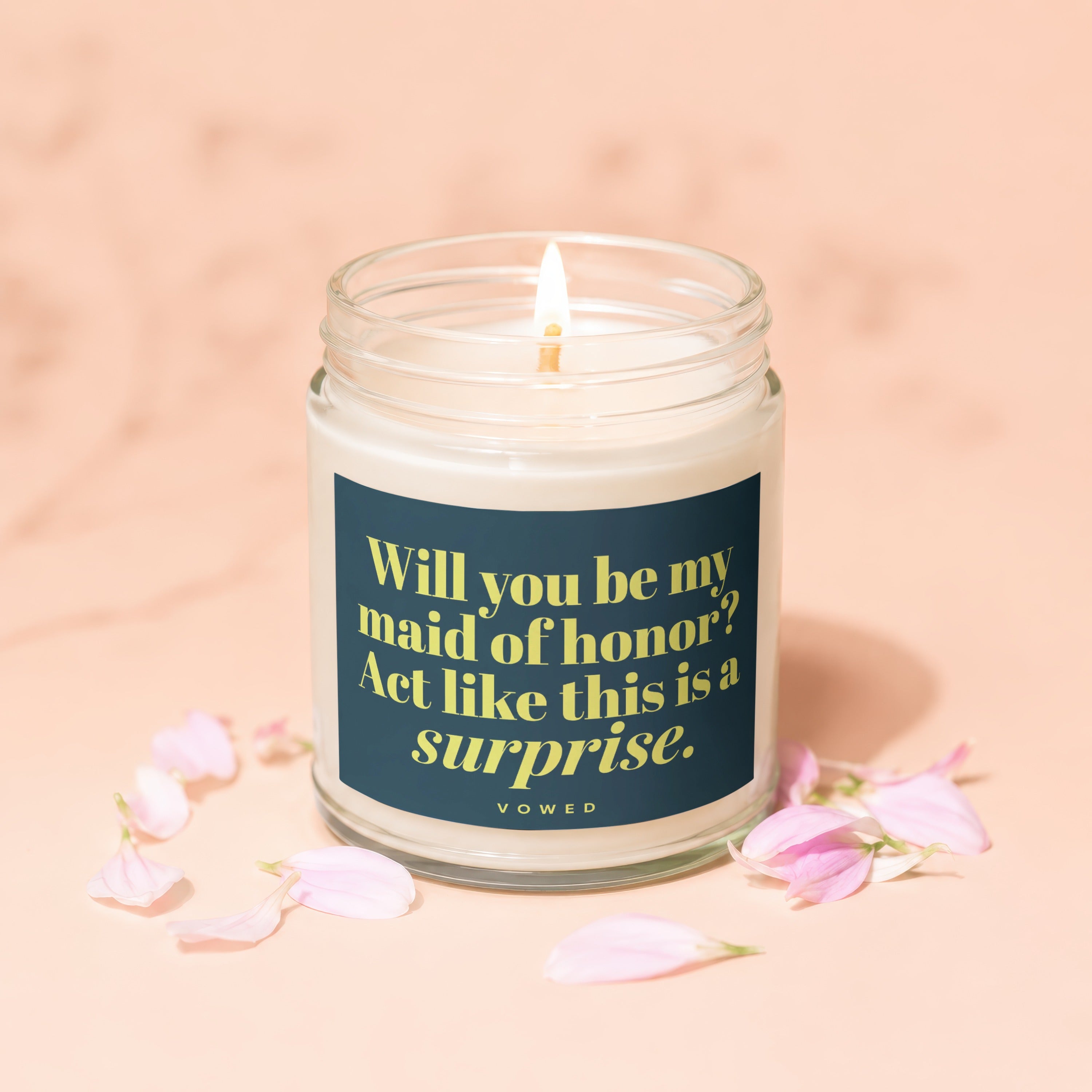 Candle with the text "Will you be my maid of honor? Act like this is a surprise. VOWED."
