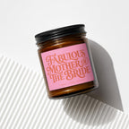 Amber jar candle with pink label reading "Fabulous Mother of the Bride".