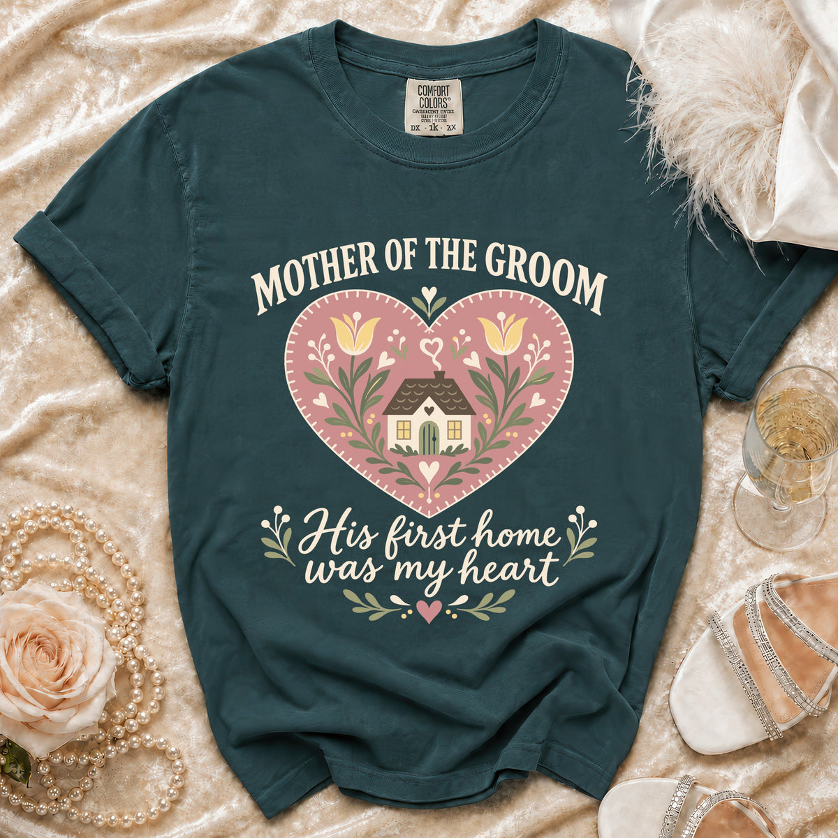 Dark teal t-shirt with "Mother of the Groom His first home was my heart" text.