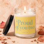 Candle with text "Proud of you two" and "VOWED" on yellow label.