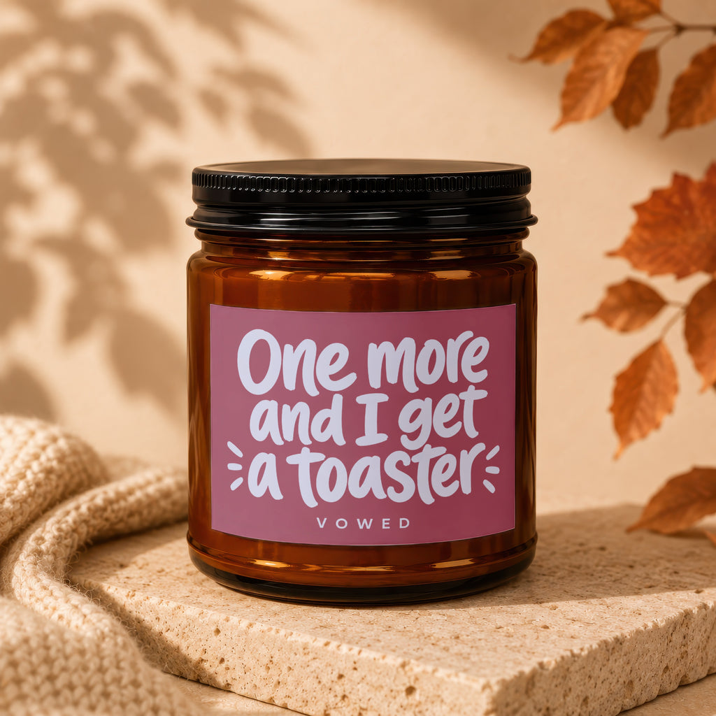 Amber jar candle with text "One more and I get a toaster VOWED".