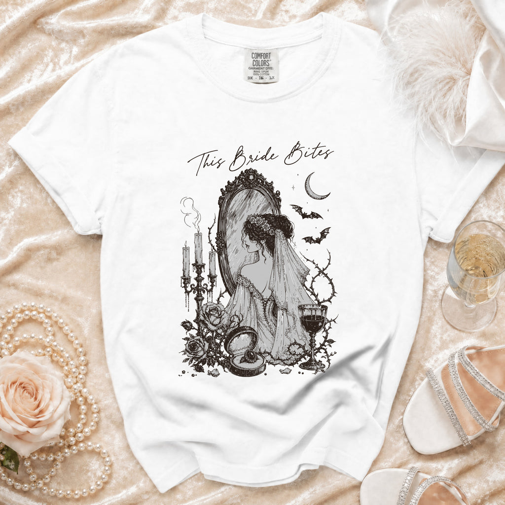 White t-shirt with "This Bride Bites" graphic featuring a bride looking in a mirror.