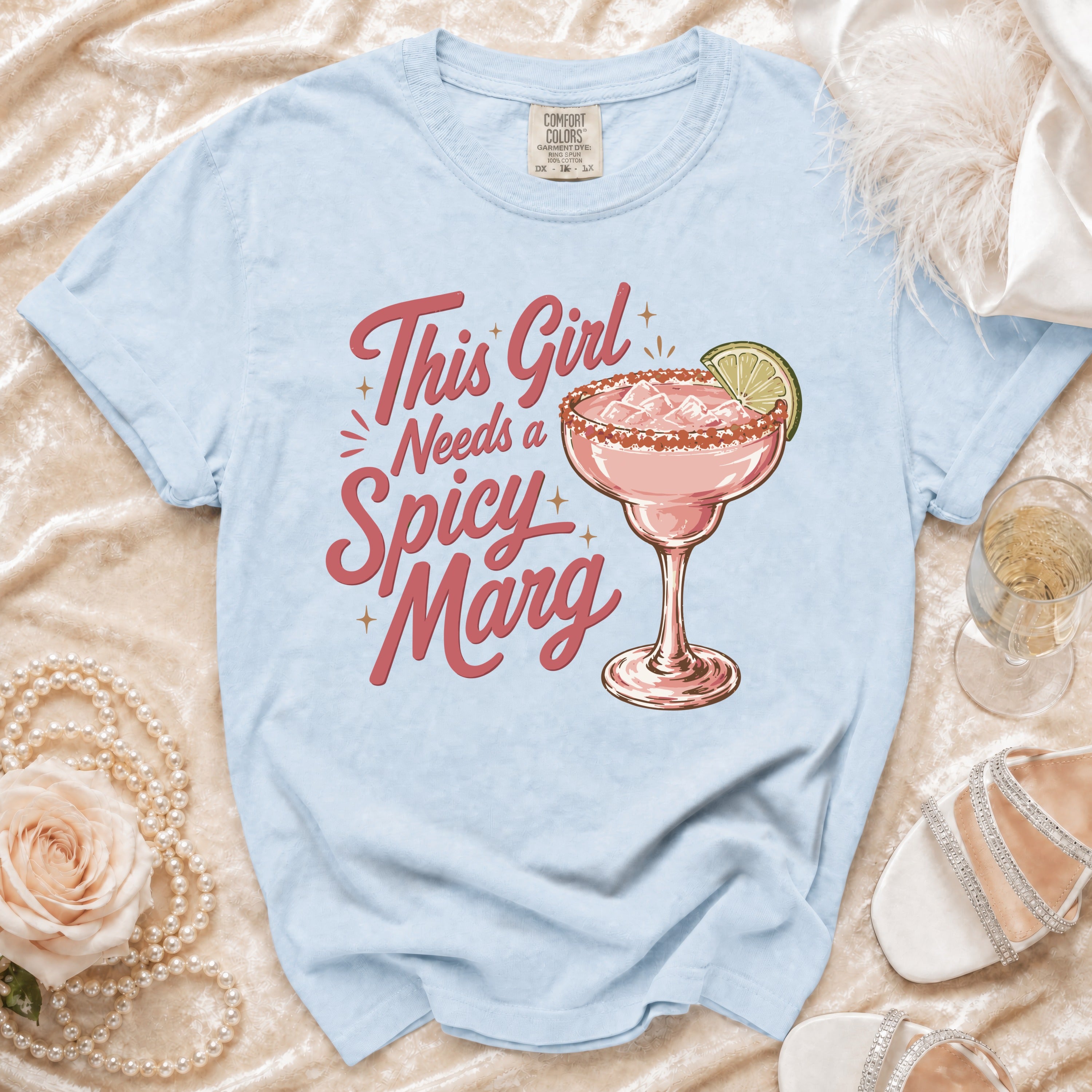 Light blue t-shirt with pink text that reads "Spicy Marg."