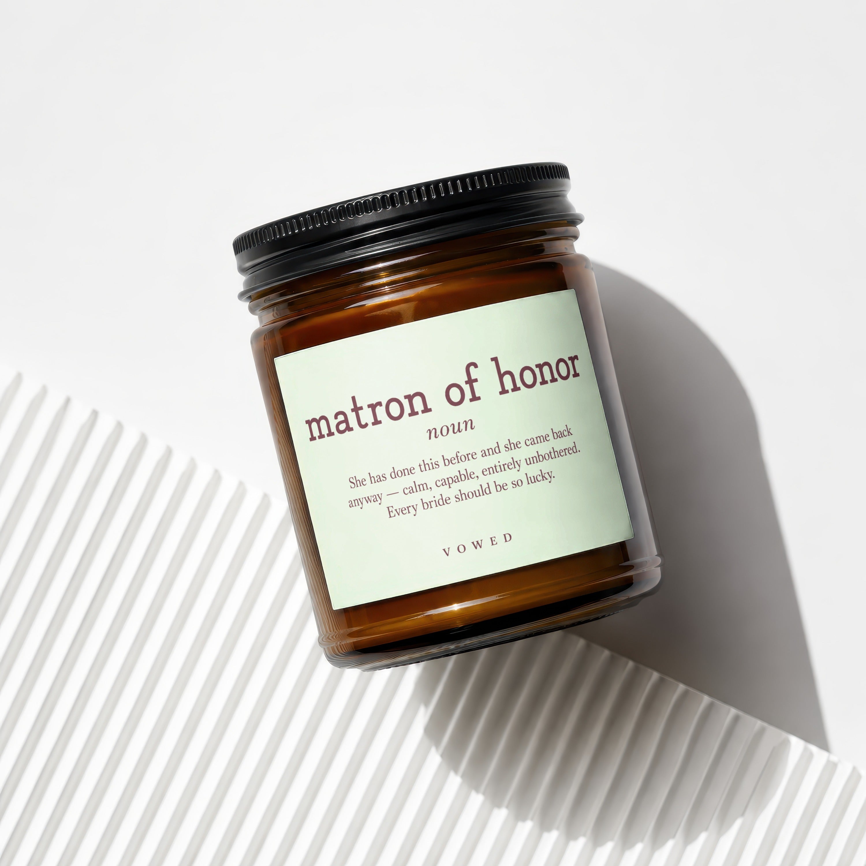 Brown glass candle with "matron of honor" label and descriptive text.