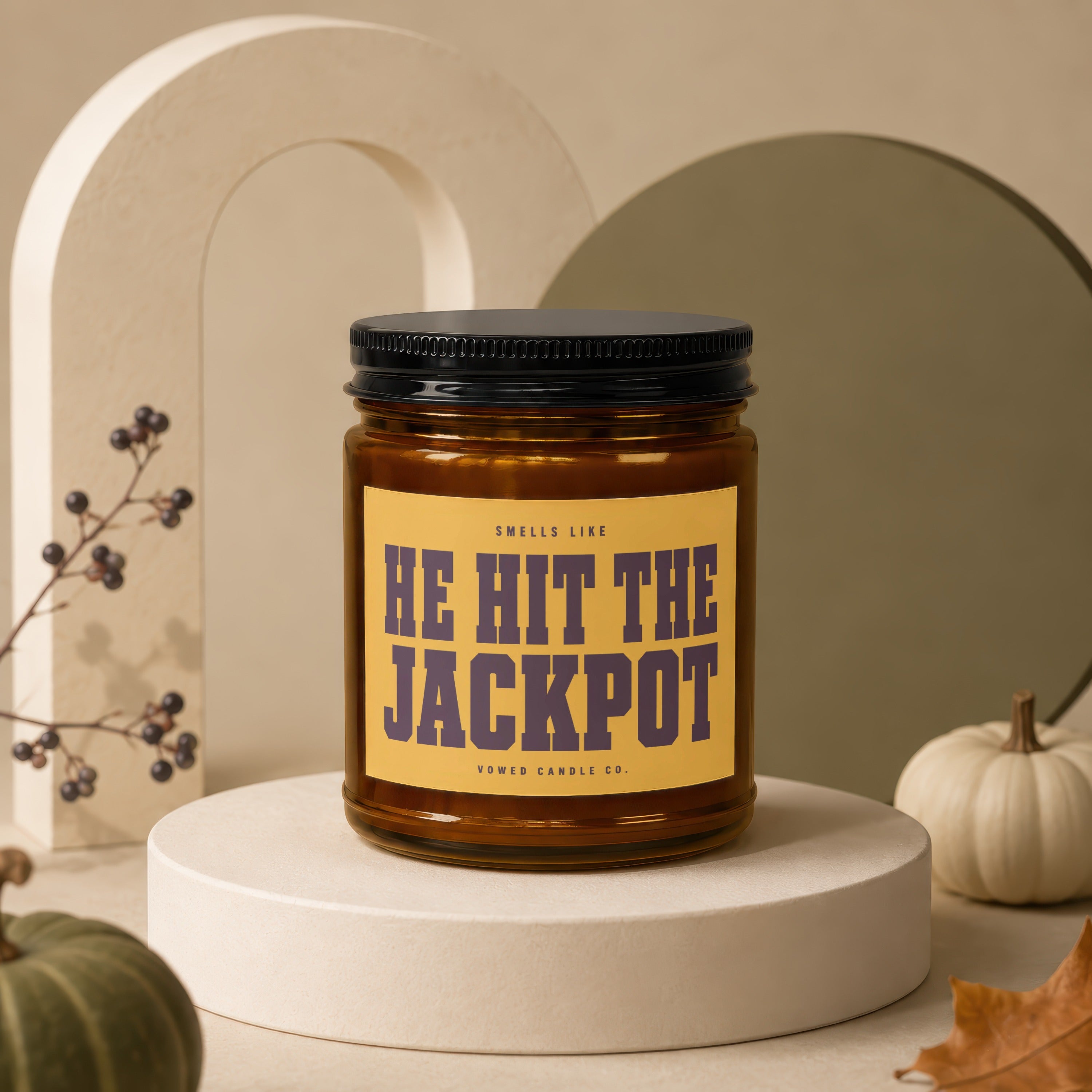 Candle with text "HE HIT THE JACKPOT" on a yellow label.