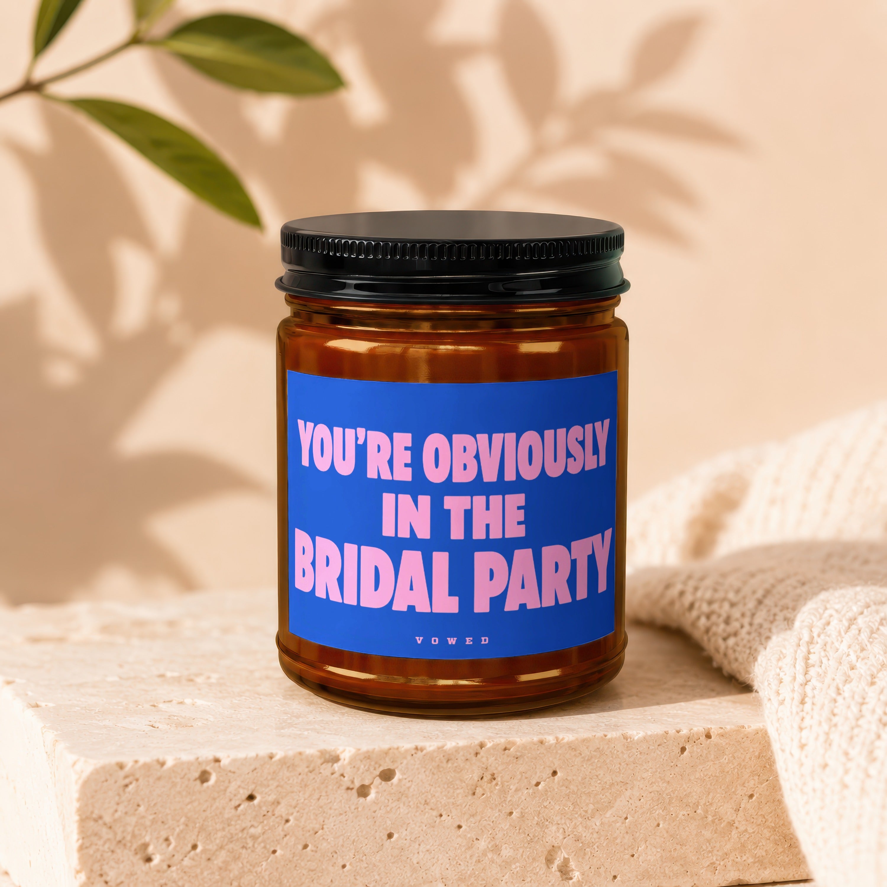 Amber jar candle with black lid, blue label reads "YOU'RE OBVIOUSLY IN THE BRIDAL PARTY".