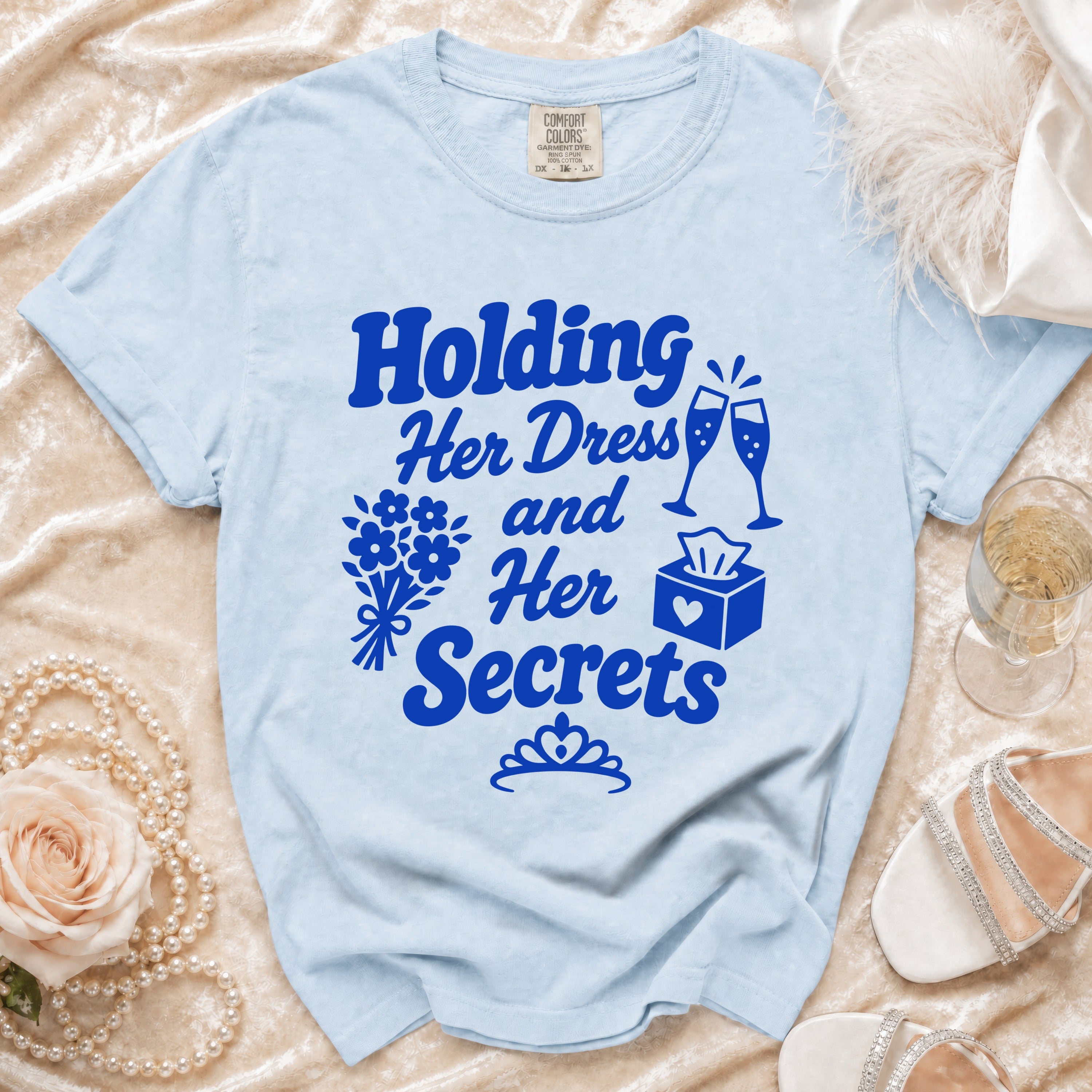 Light blue t-shirt with "Holding Her Dress and Her Secrets" graphic.