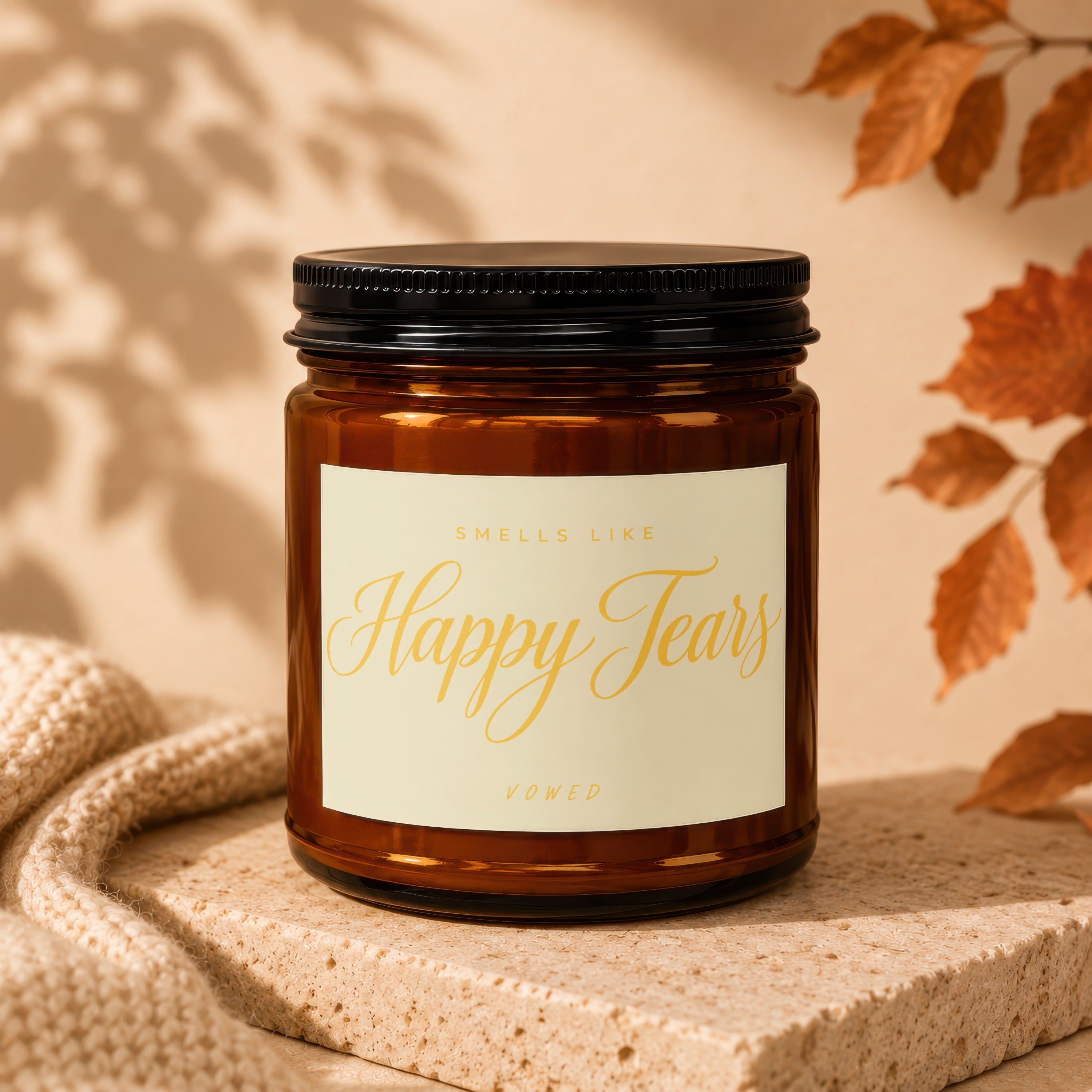 Brown amber candle with "Smells Like Happy Tears, Vowed" text.