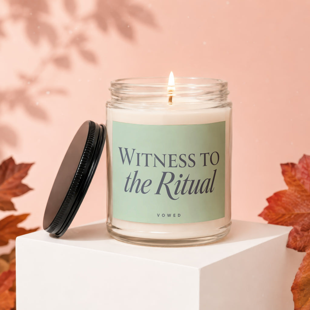 Lit candle in a glass jar with a black lid, labeled "Witness to the Ritual Vowed."