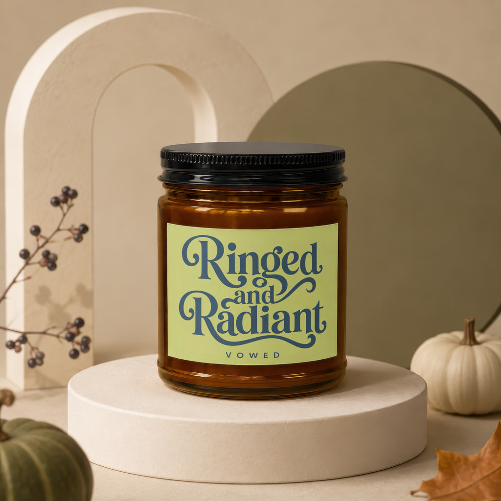 Brown glass candle with a label reading "Ringed and Radiant" and "vowed".