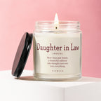 Lit candle in jar with "Daughter in Law" definition on label.