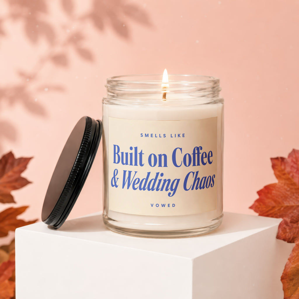 Jar candle with lit wick, "Smells like Built on Coffee & Wedding Chaos" label.