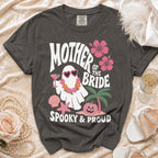 Dark gray t-shirt with "Mother of the Bride Spooky & Proud" text and ghost graphic.
