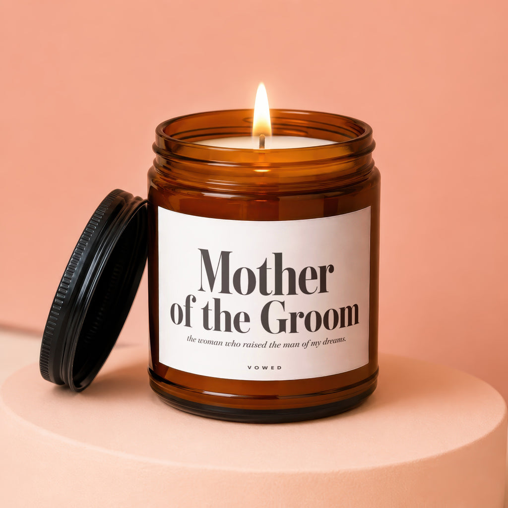 Amber glass candle with lid askew, reads "Mother of the Groom."