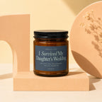 Brown glass candle labeled "I Survived My Daughter's Wedding."