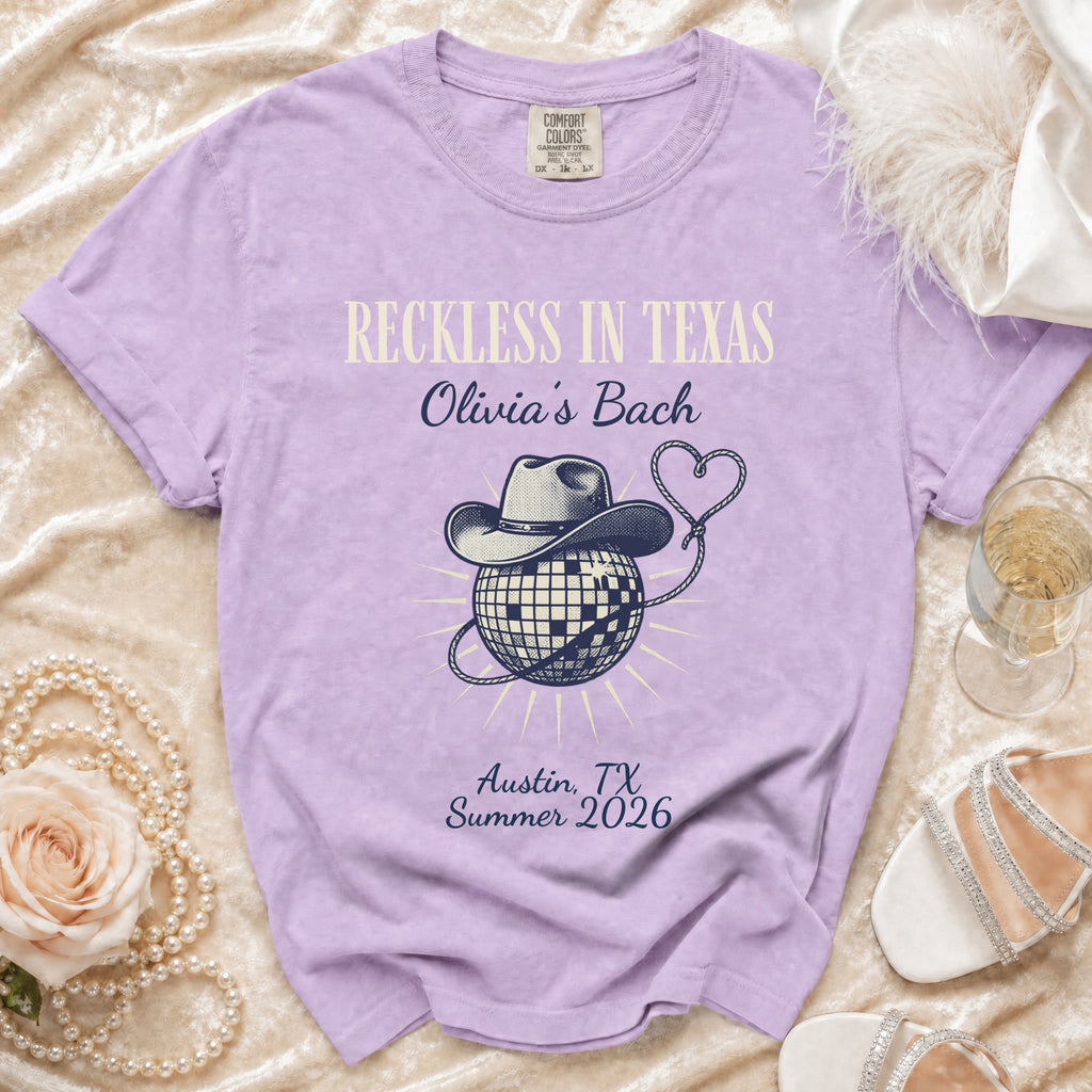 Purple t-shirt with "Reckless in Texas Olivia's Bach" and disco ball graphic.