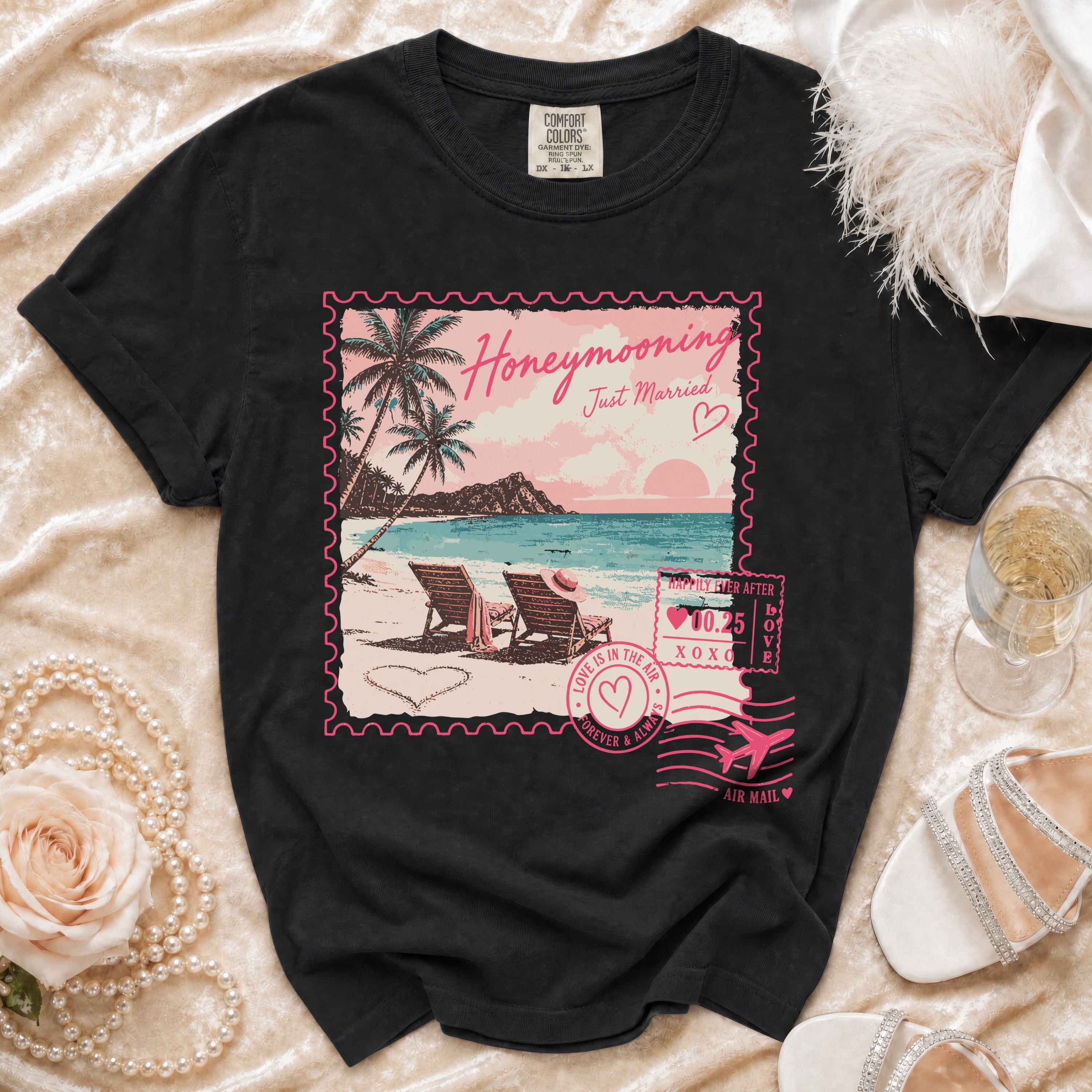 Black t-shirt with "Honeymooning Just Married" tropical scene resembling a postcard stamp.