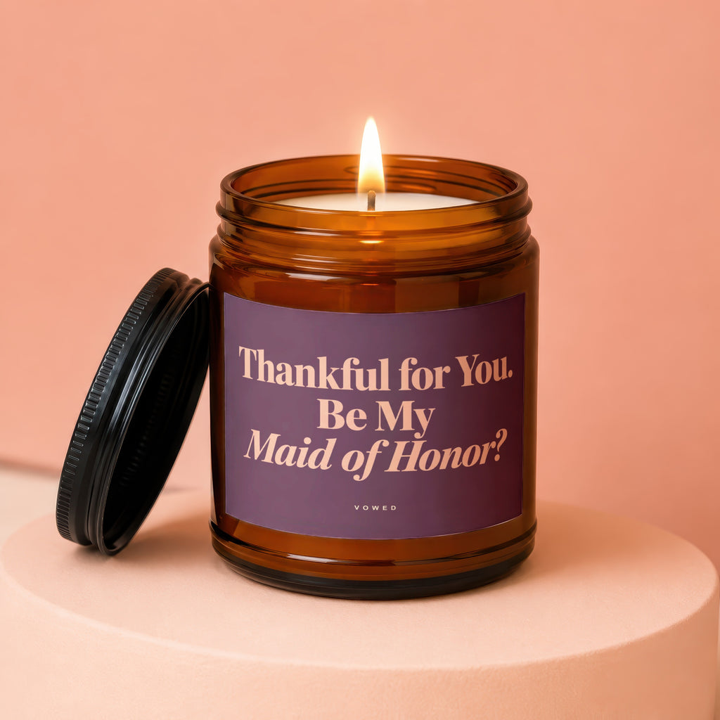Amber jar candle with lit wick and lid askew, text reads "Thankful for You. Be My Maid of Honor?".