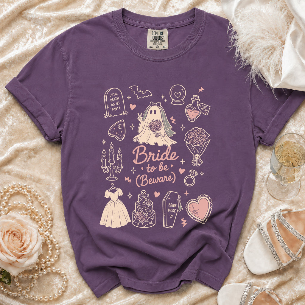 Purple t-shirt with "Bride to be (Beware)" and Halloween-themed wedding graphics.