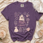 Purple t-shirt with "Bride to be (Beware)" and Halloween-themed wedding graphics.