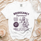 White t-shirt with Bridegancy Department graphic and 1-800-BRIDE-HELP phone number.