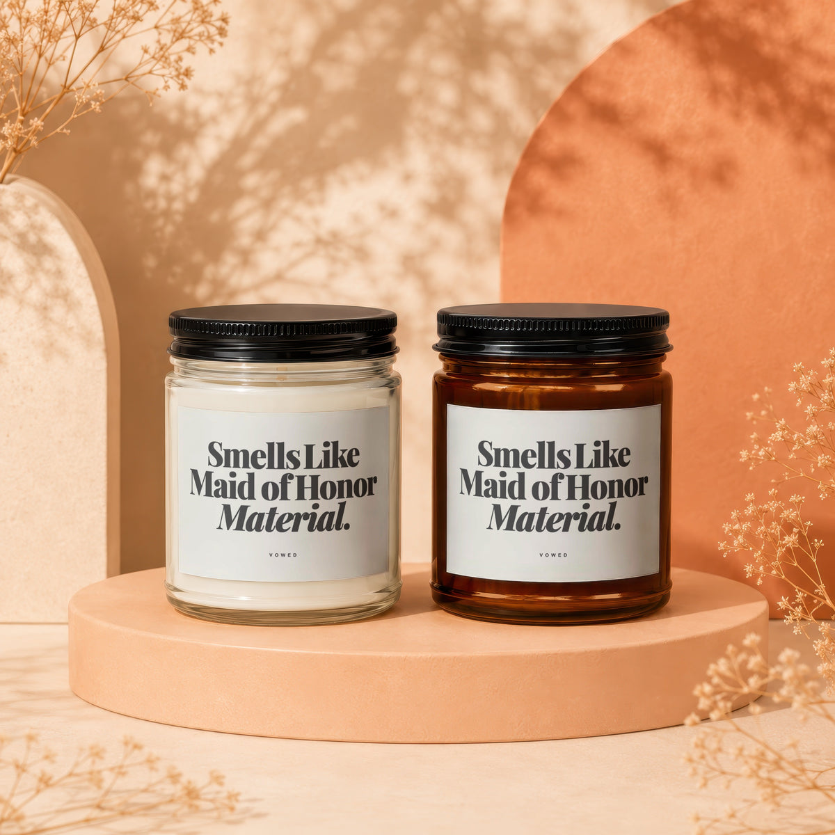 Two candles with "Smells Like Maid of Honor Material" text on labels.