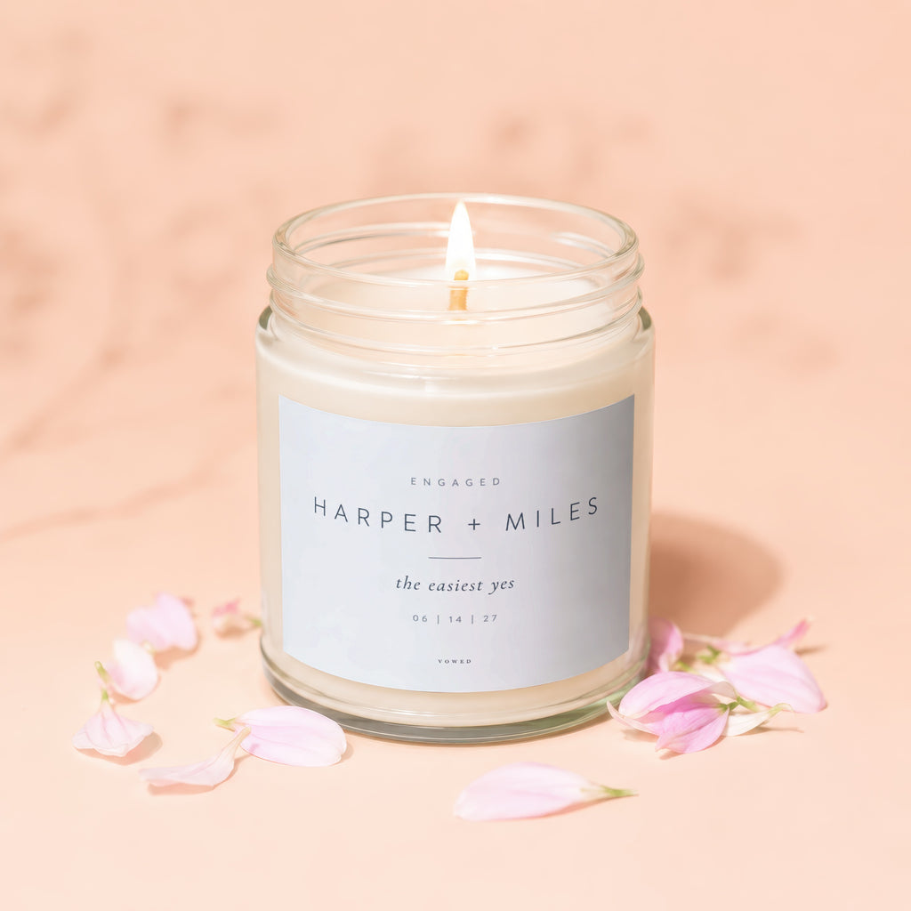 Candle with label "Engaged Harper + Miles the easiest yes 06 | 14 | 27".