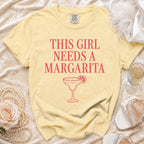 Yellow t-shirt with "This Girl Needs a Margarita" and a margarita graphic.