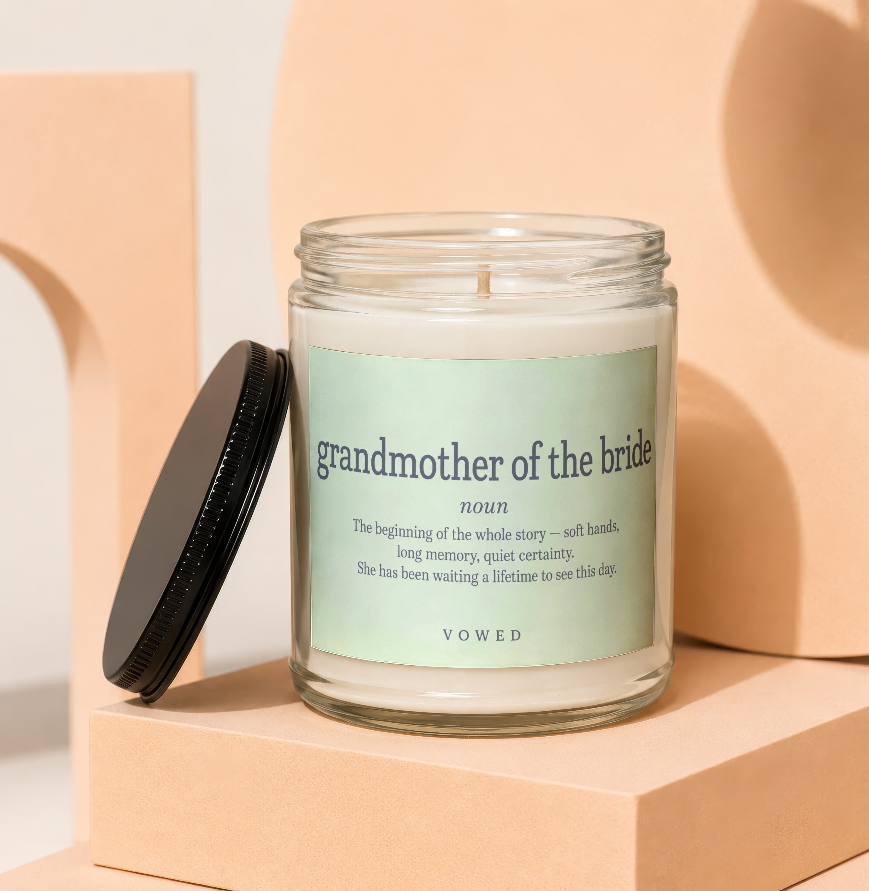 Glass candle with pale green label: "grandmother of the bride noun" and descriptive text.