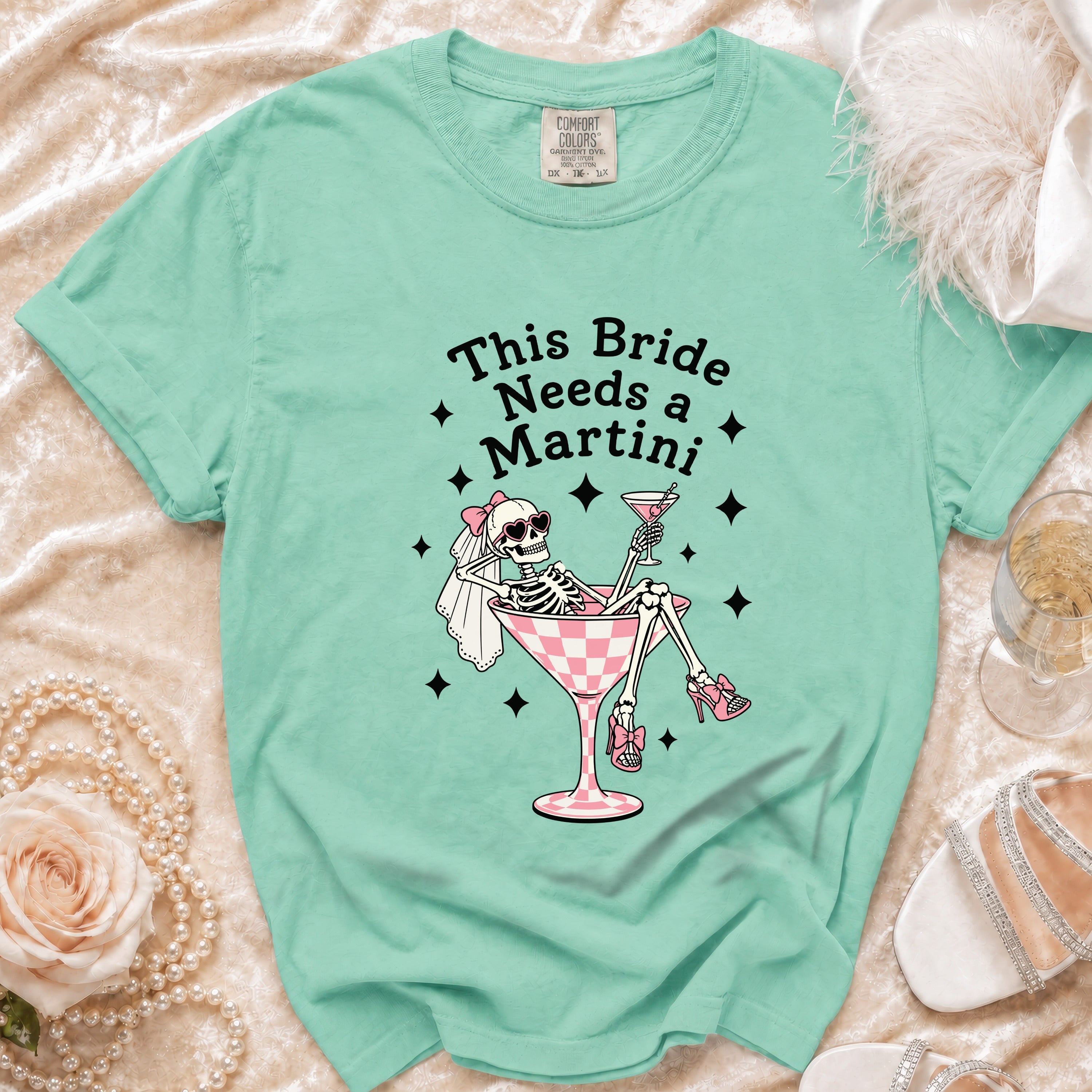 Mint green t-shirt with skeleton bride graphic and "This Bride Needs a Martini" text.