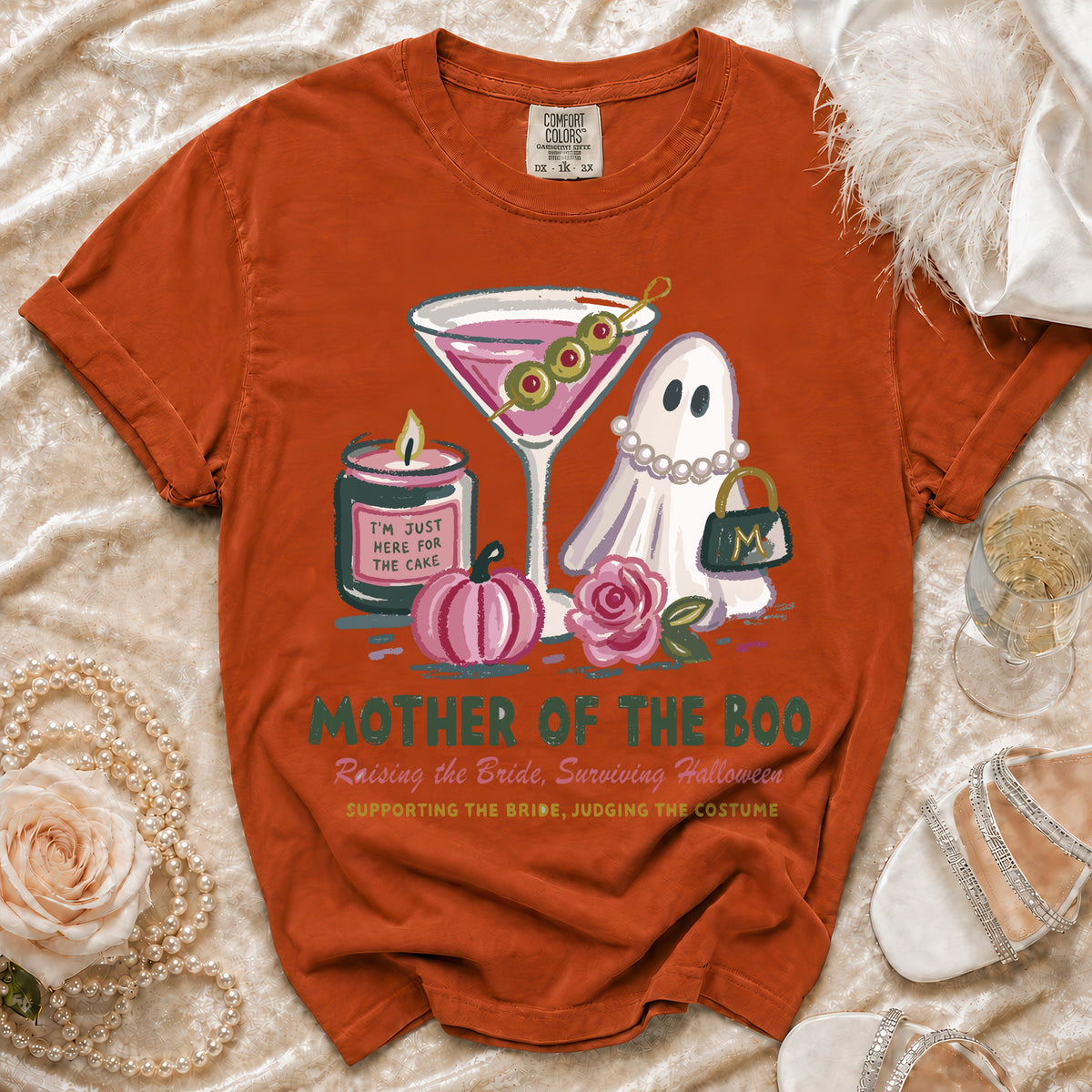Orange t-shirt with ghost, martini, candle, and pumpkin graphics. Text: Mother of the Boo.