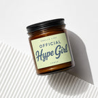 Amber glass candle with black lid, label reads "OFFICIAL Hype Girl".