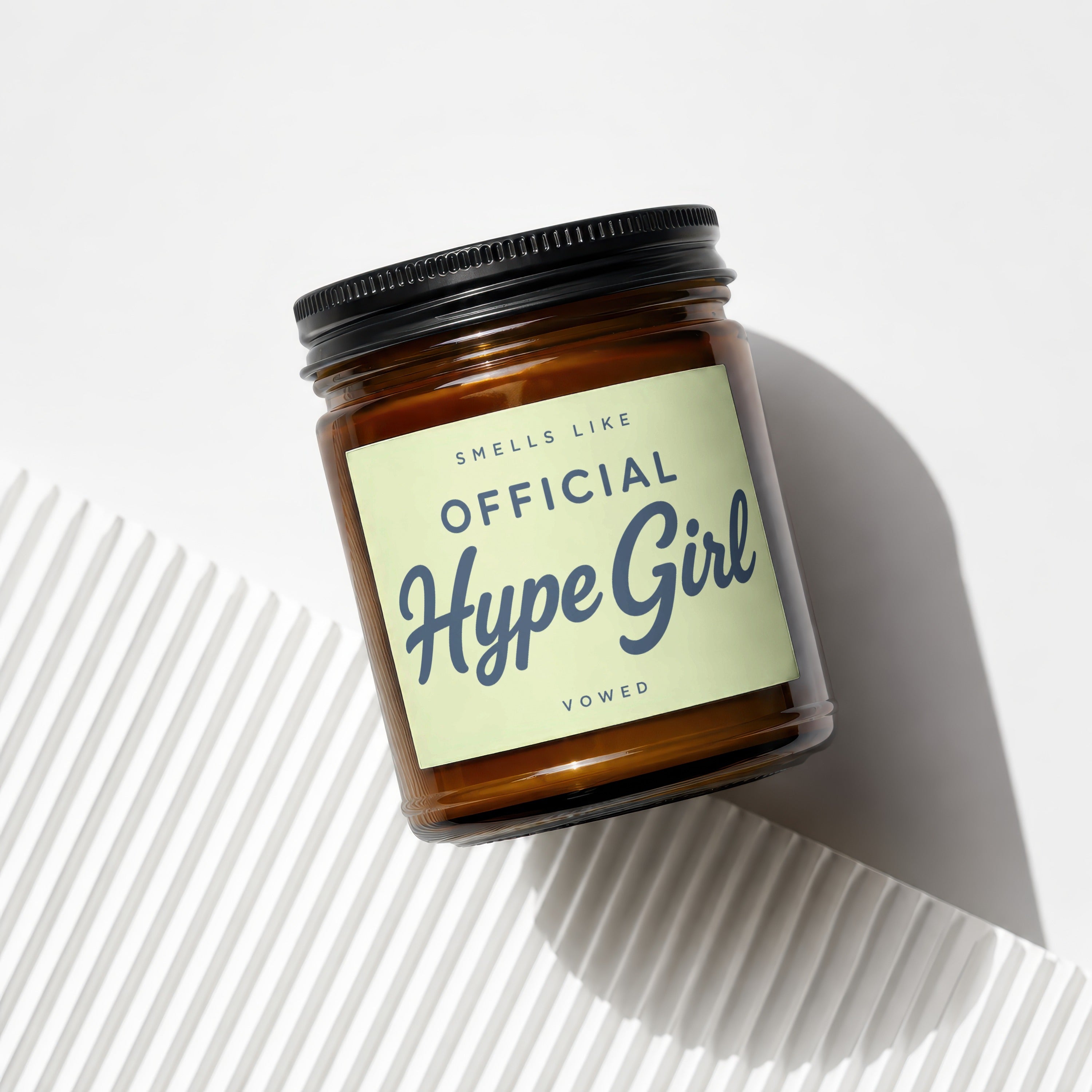 Amber glass candle with black lid, label reads "OFFICIAL Hype Girl".