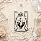 Cream t-shirt for "The Bride" with mystical hands, moon, and stars graphic.