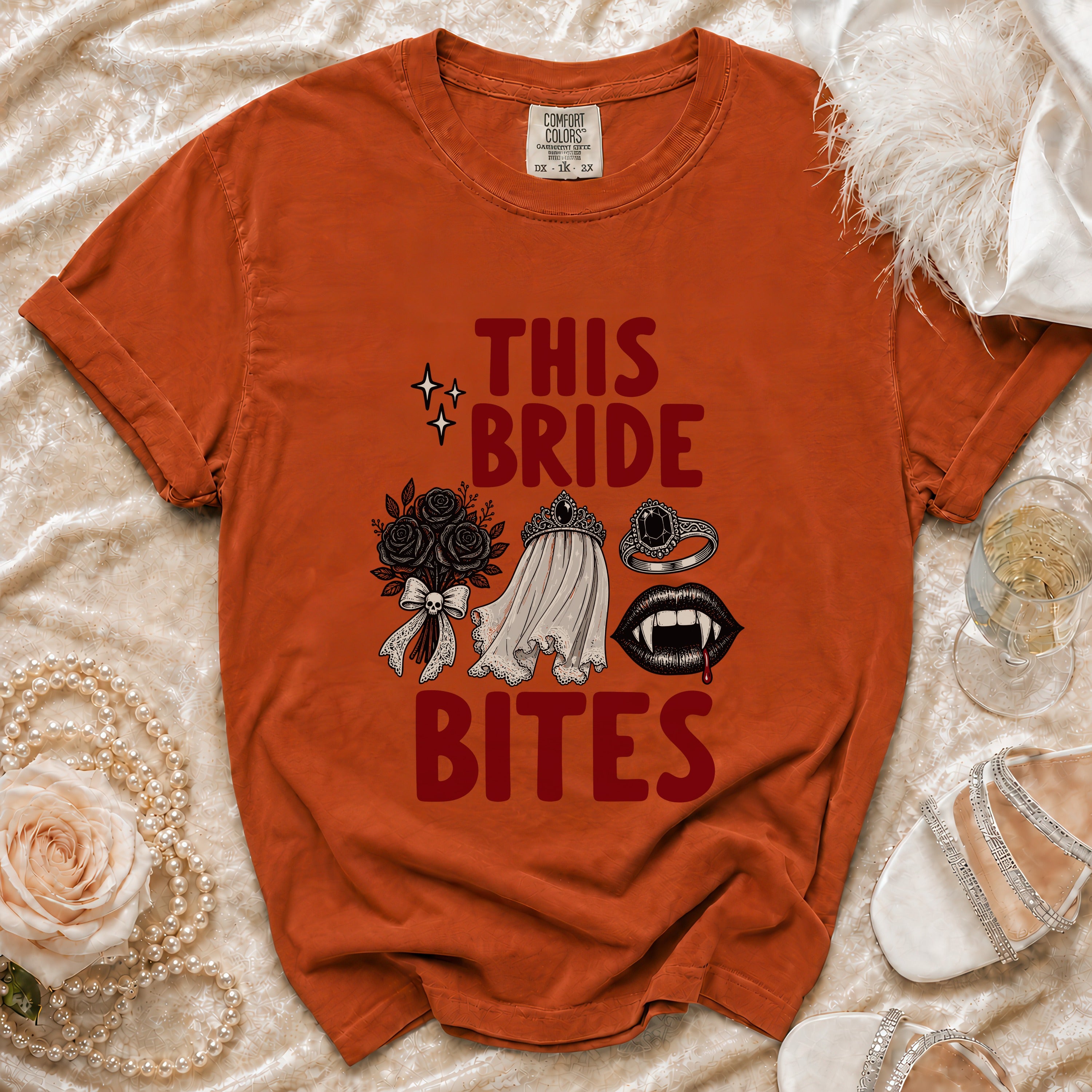 Orange t-shirt with "THIS BRIDE BITES" graphic and vampire-themed illustrations.