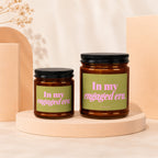 Two glass candles with "In my engaged era." text on green labels.