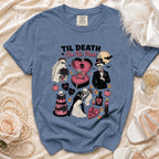 Blue t-shirt with "Til Death Do Us Part" graphic featuring skeletons, a ghost, and wedding elements.