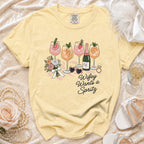 Yellow t-shirt with "Wifey Wants a Spritz" text and illustrations of drinks, flowers, and accessories.